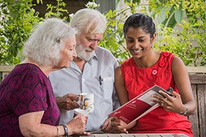 Young woman showing seniors information booklet 
